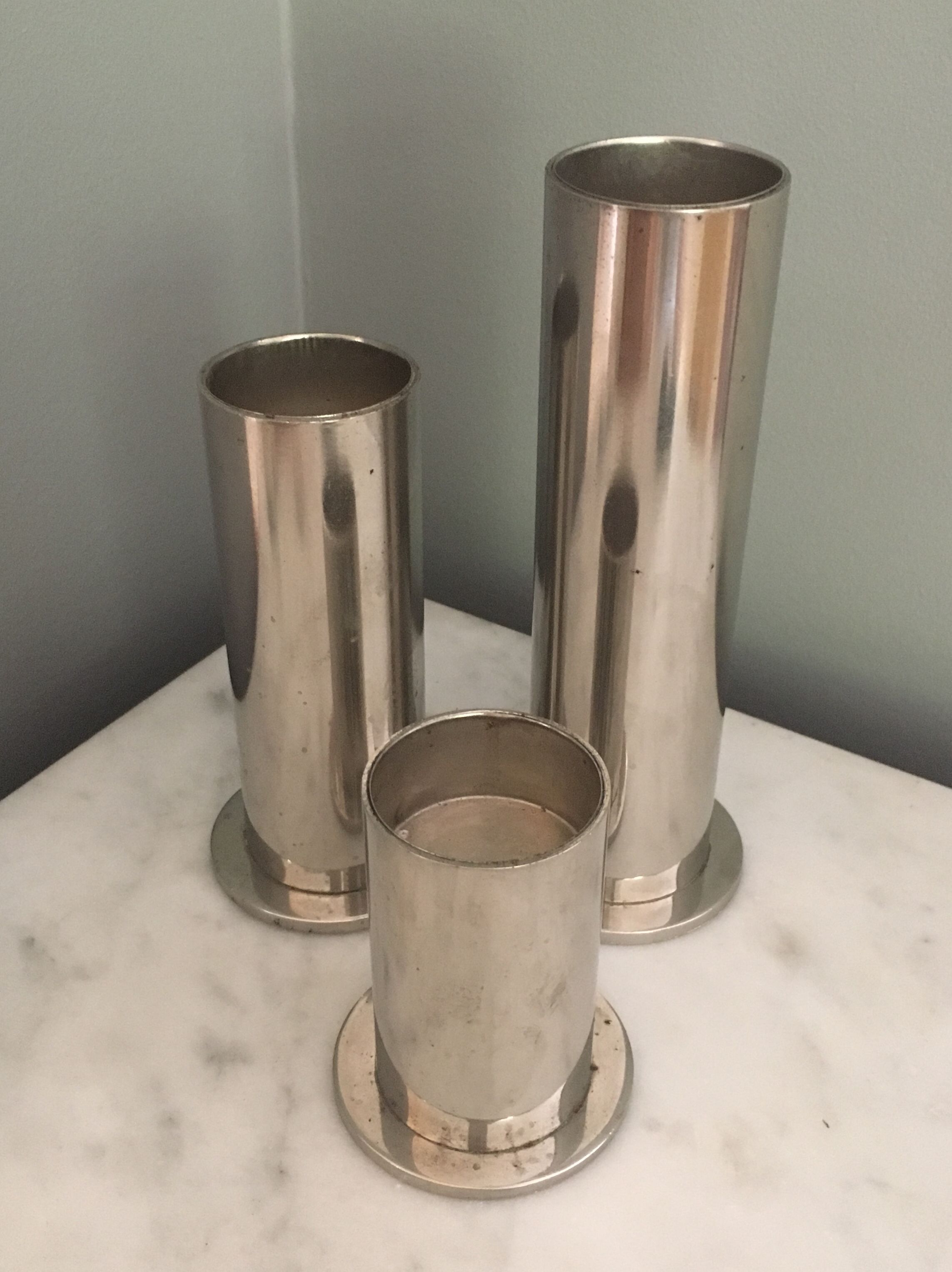 Suite of three brushed steel candlesticks from the 1970s