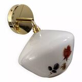 Golden tilting wall light with flowered globe