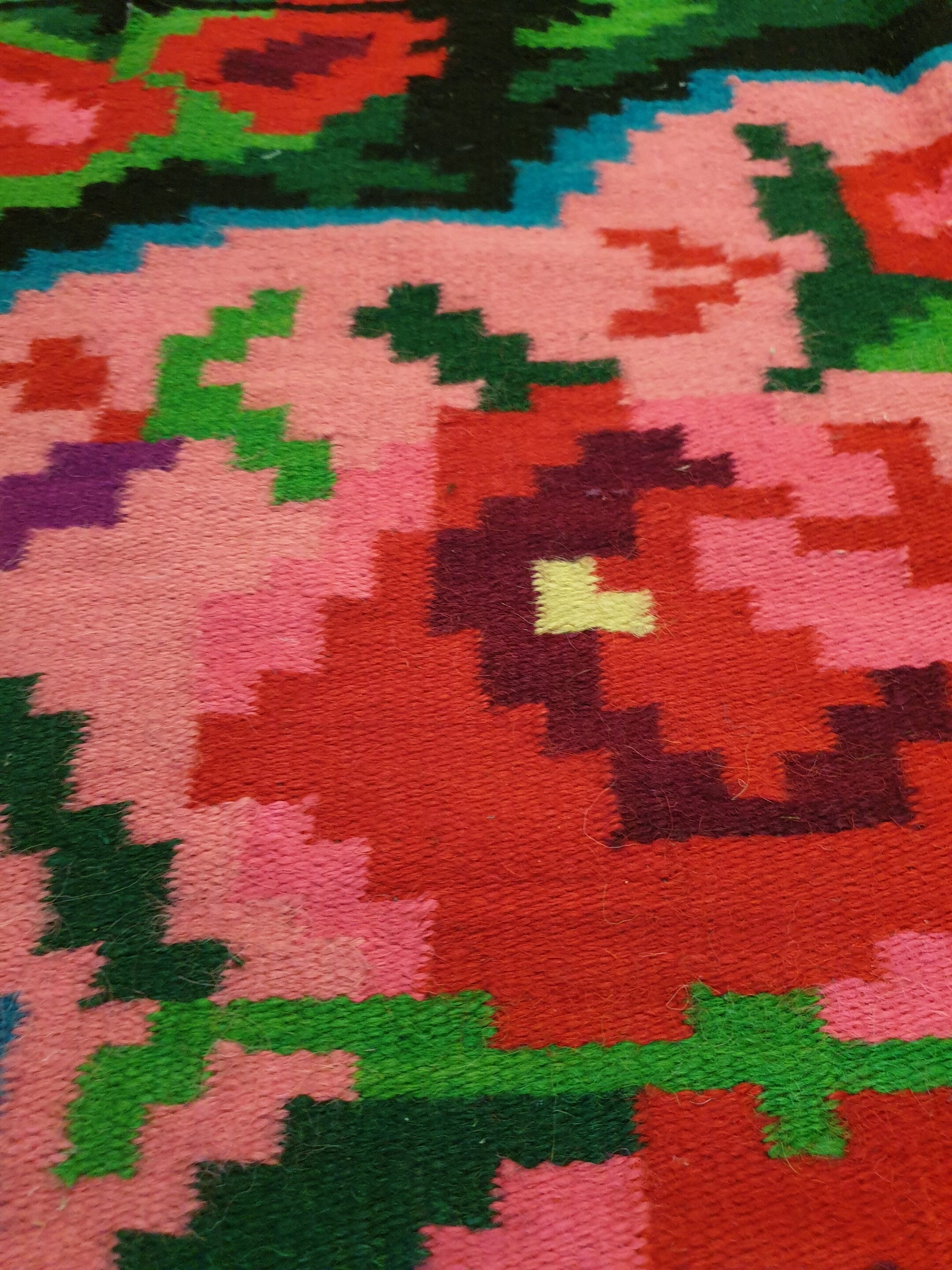 Colorful kilim on black background with floral design