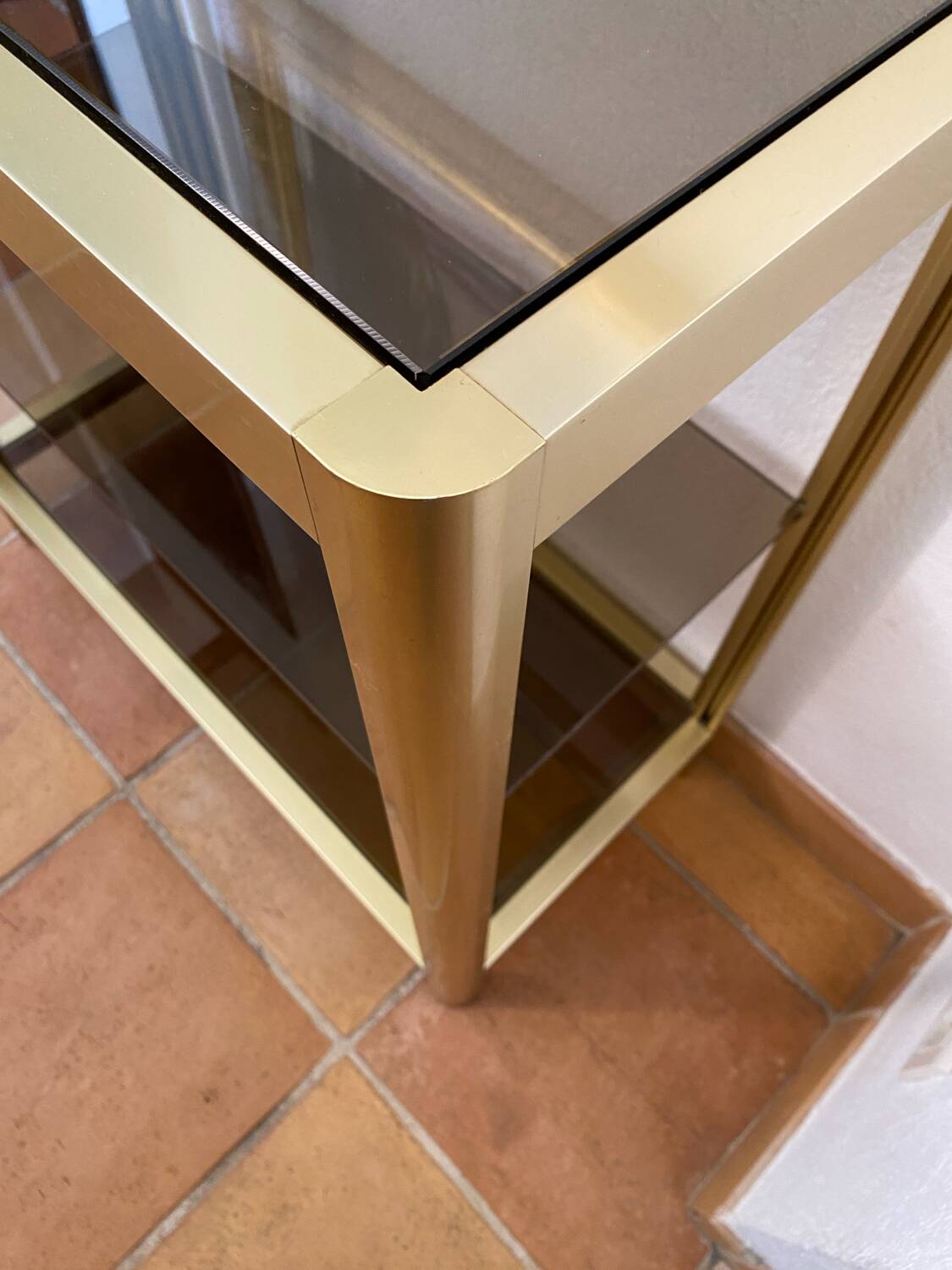 Regency style console table, in gilded metal and smoked glass