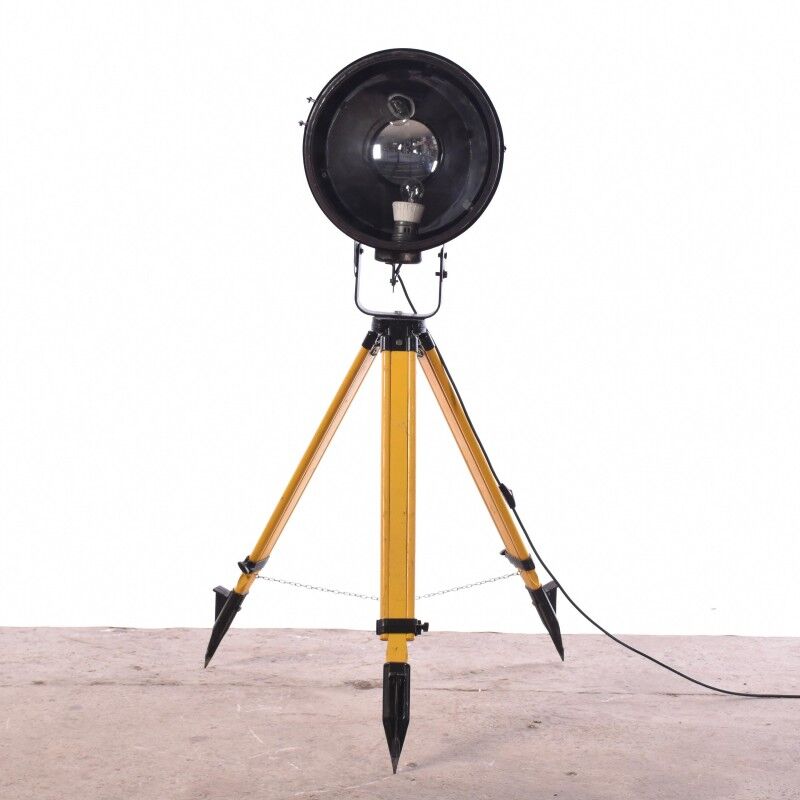 Old industrial spot on wooden tripod