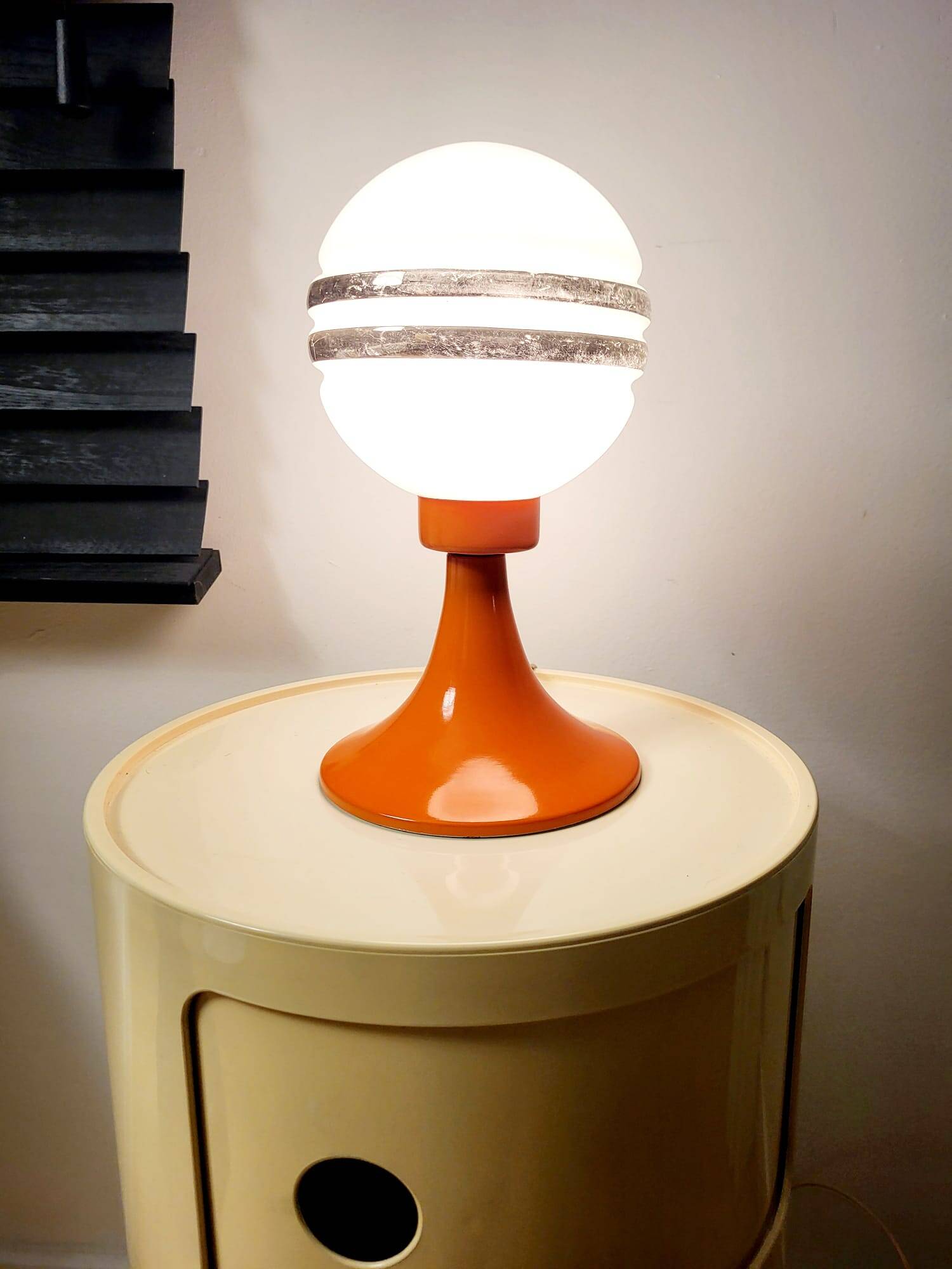 Orange metal and glass table lamp, circa 1960.
