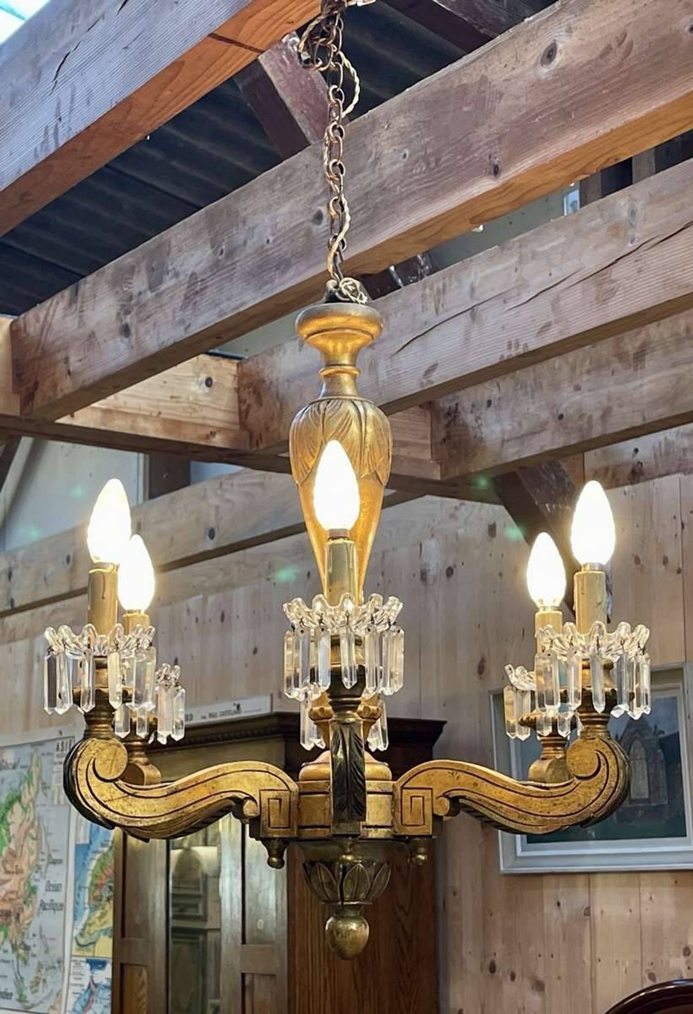 Golden wooden chandelier with crystal pendants from the 19th century.