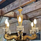 Golden wooden chandelier with crystal pendants from the 19th century.