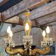 Golden wooden chandelier with crystal pendants from the 19th century.