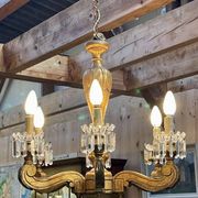 Golden wooden chandelier with crystal pendants from the 19th century.