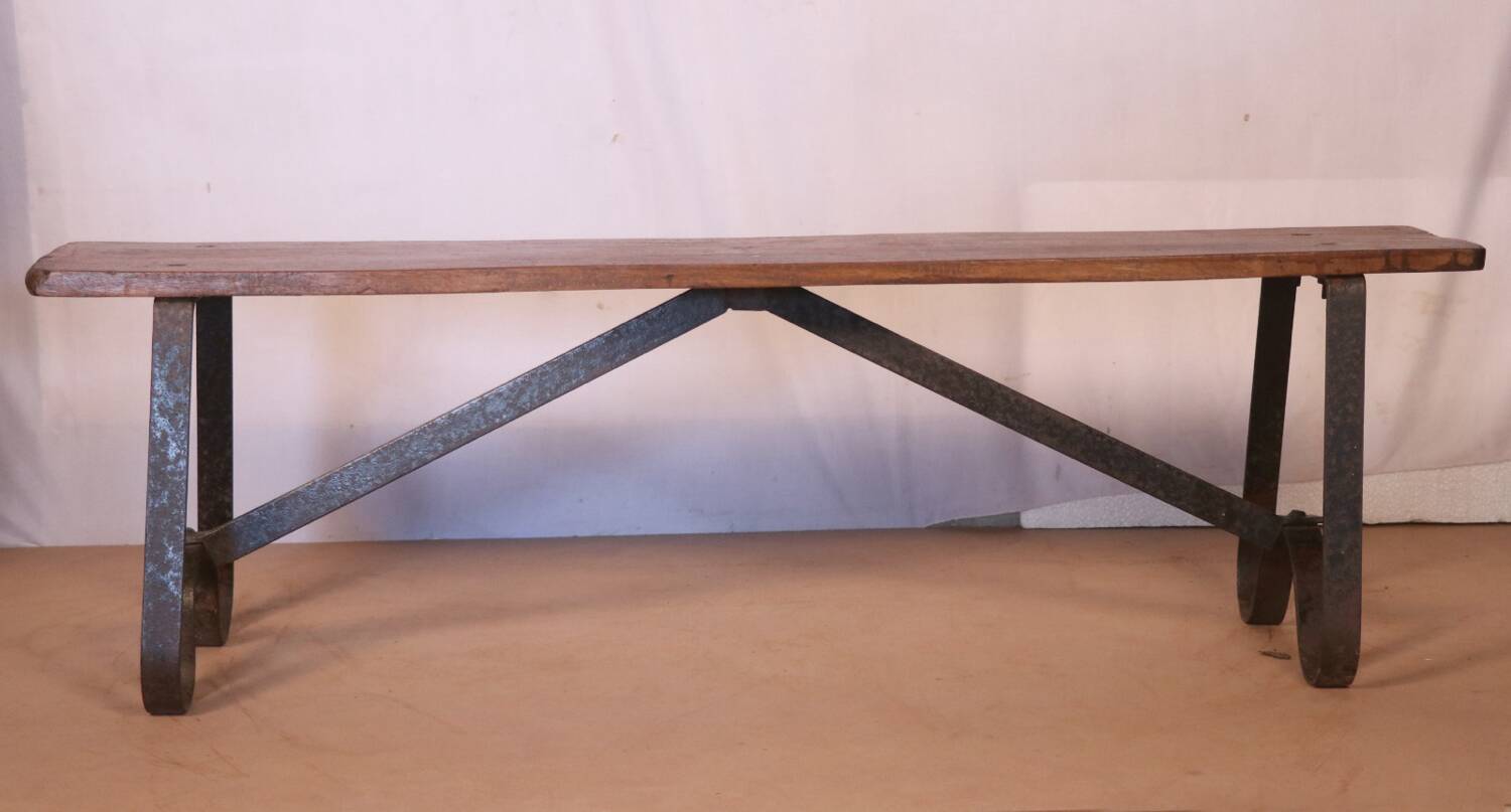 Old bench in Burmese teak with a wrought iron base.