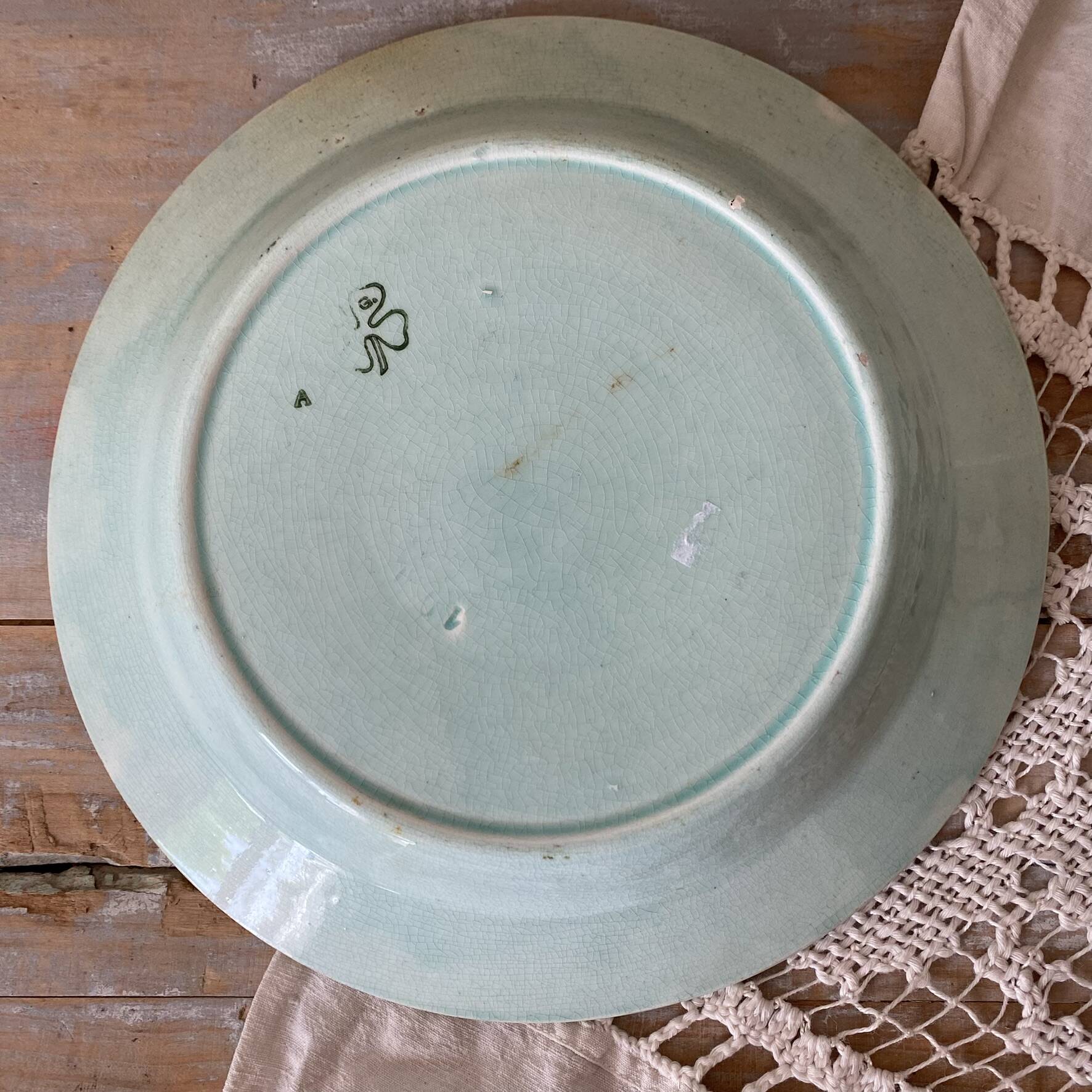 Shallow dish in slip with fruit decoration of peaches.