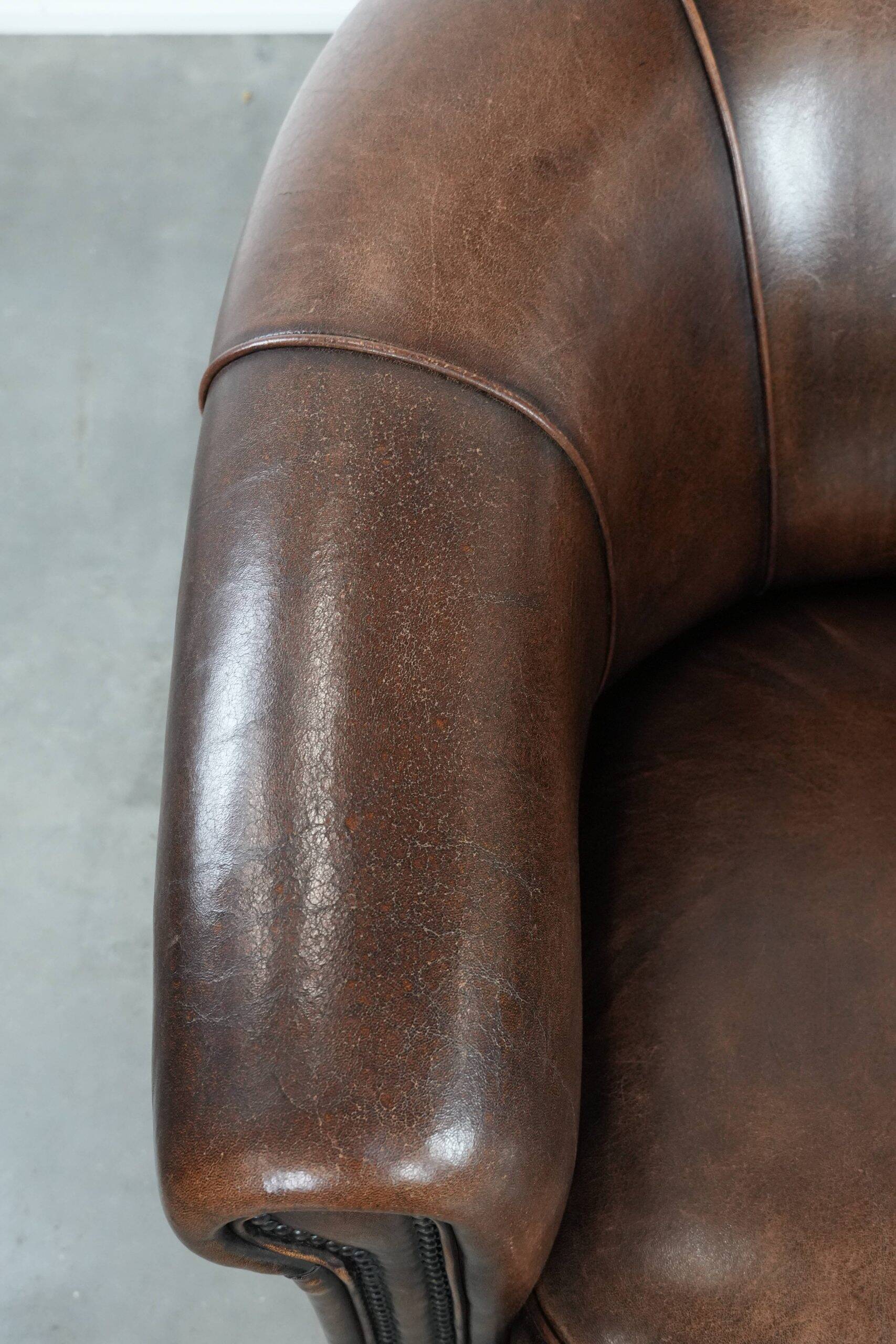 Set of two sheepskin club armchairs with fixed seat cushions