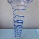 Glass vase on a pedestal with a blue trim.