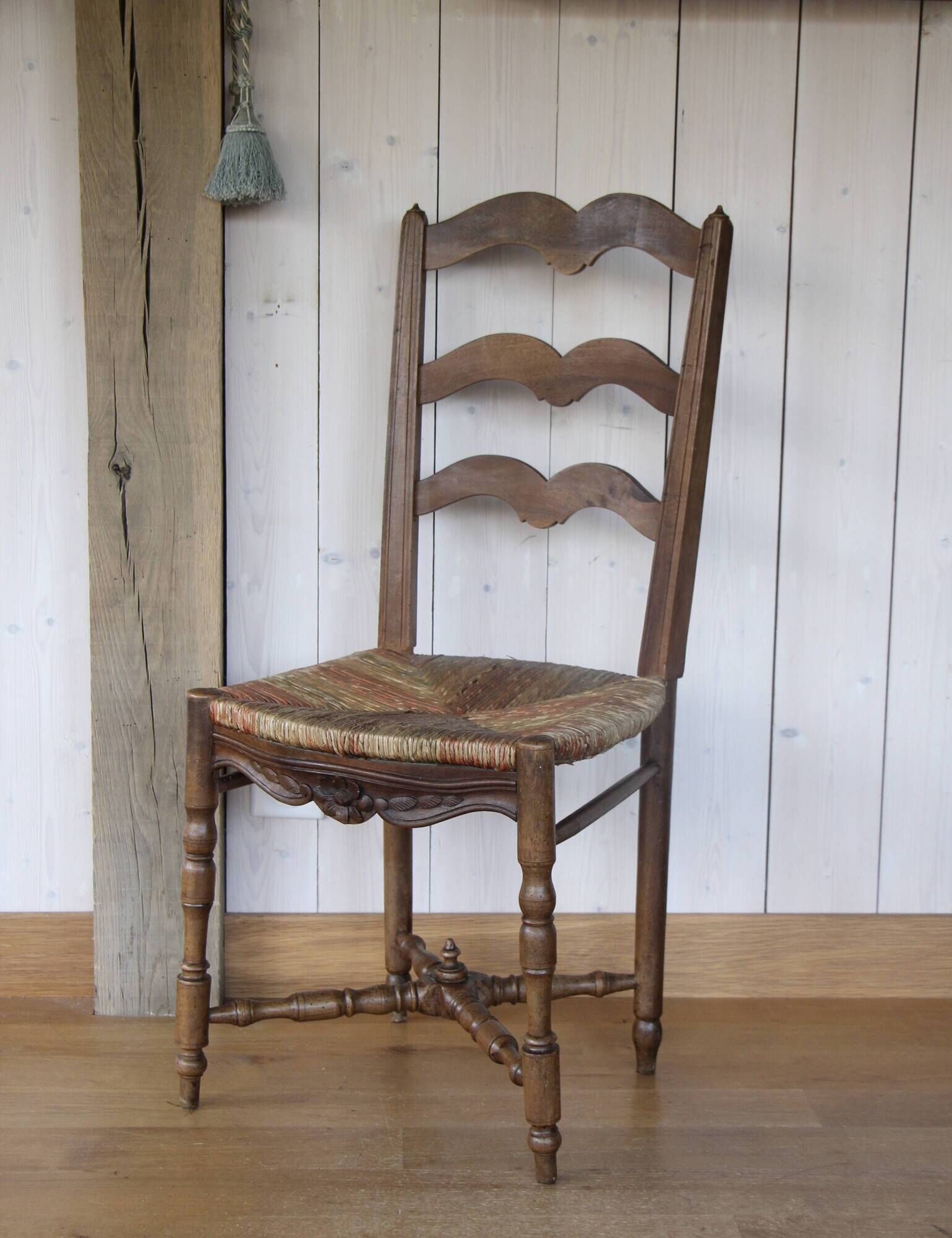 Antique chair with coloured rush seating.