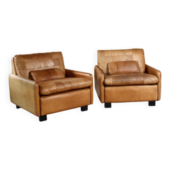 Pair of vintage patinated camel leather armchairs