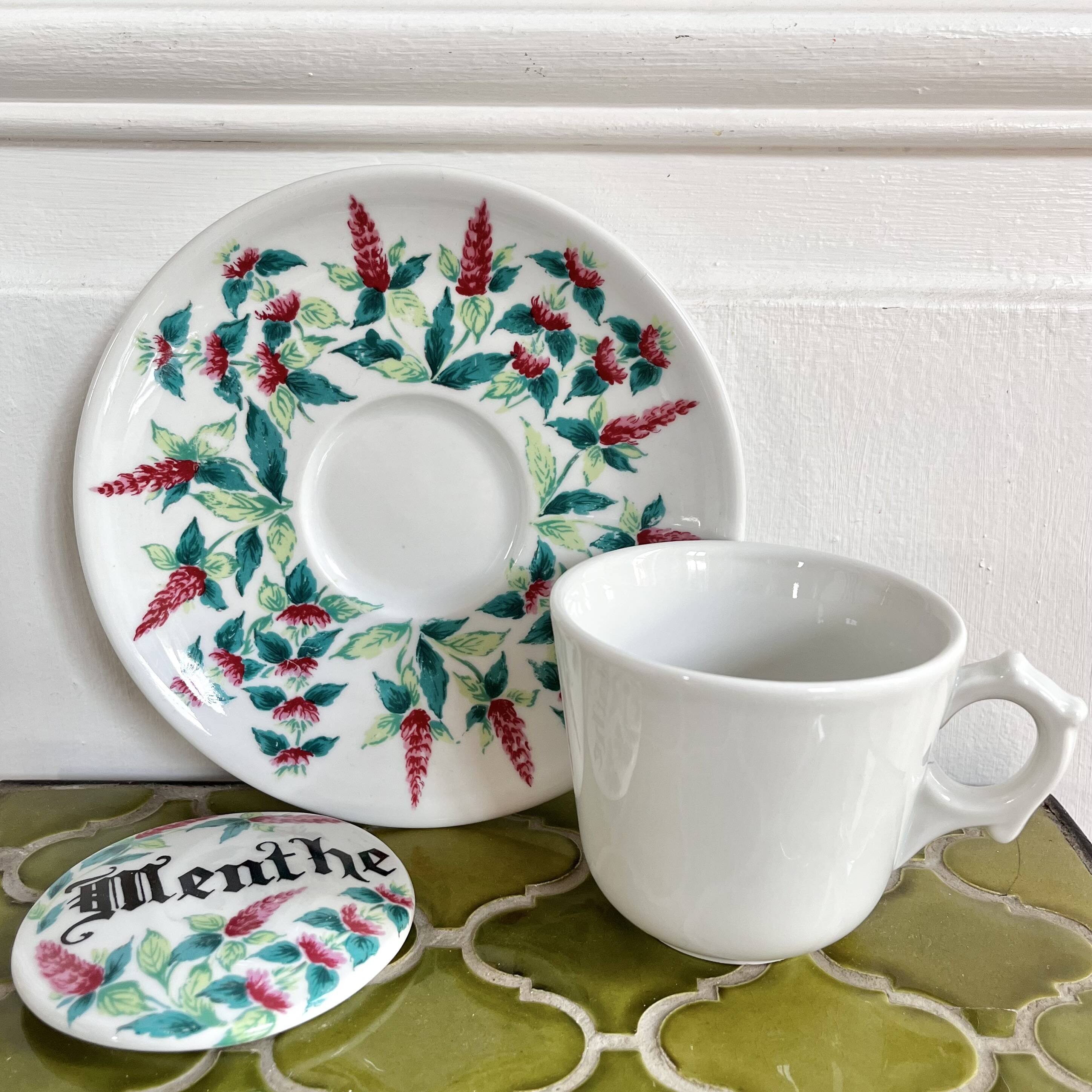 Antique herbal tea cup with mint infusion