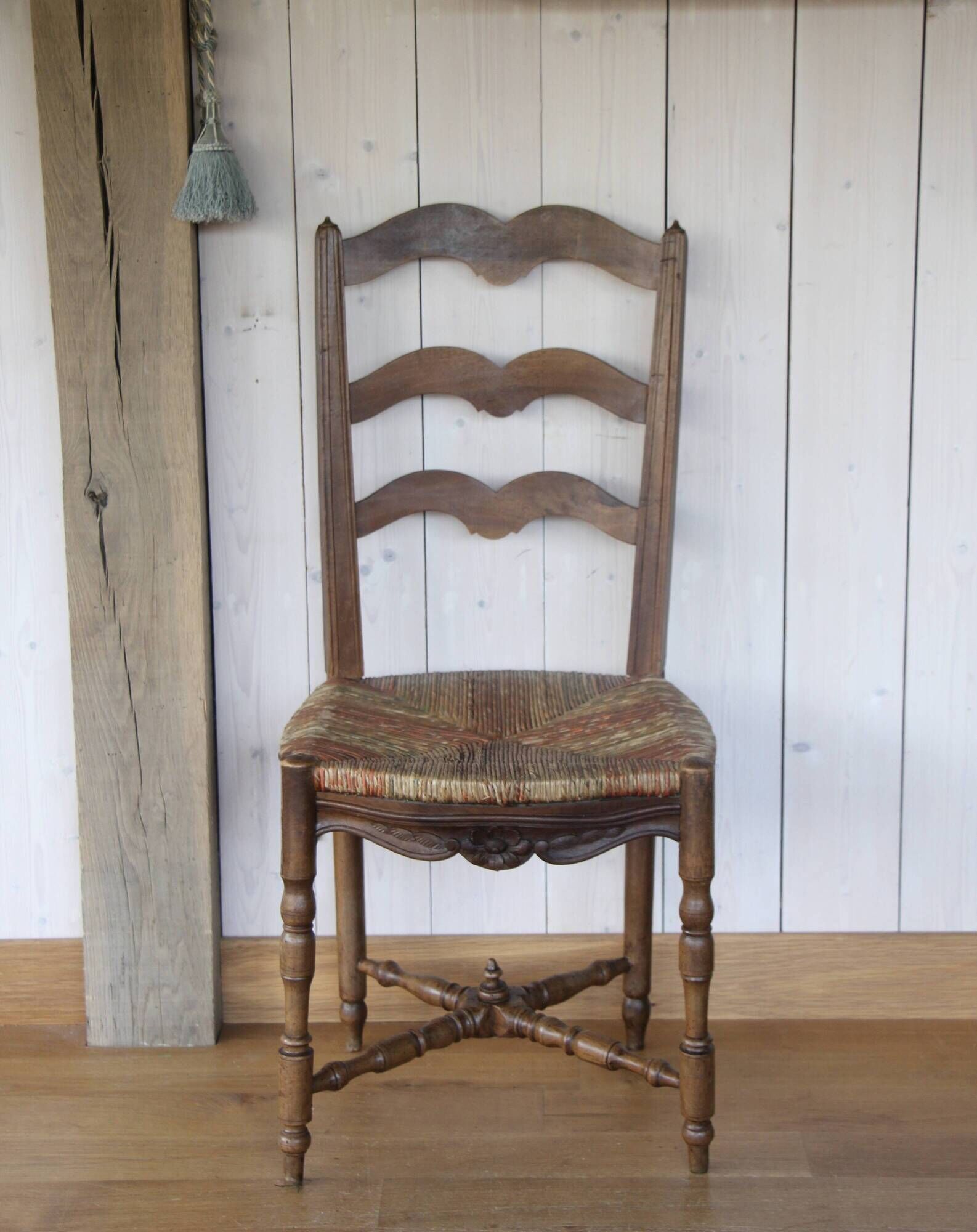 Antique chair with coloured rush seating.