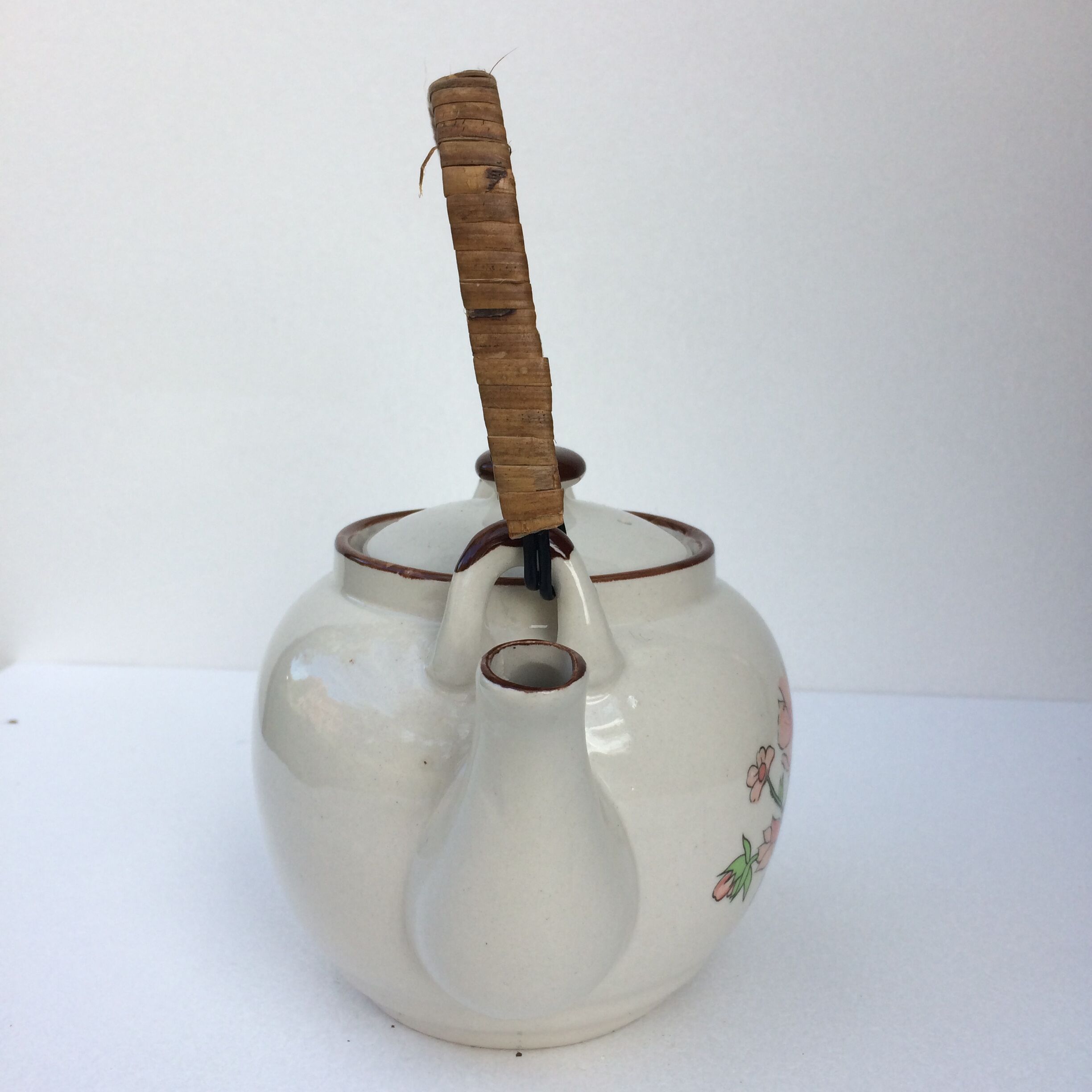 Vintage teapot with wicker handle