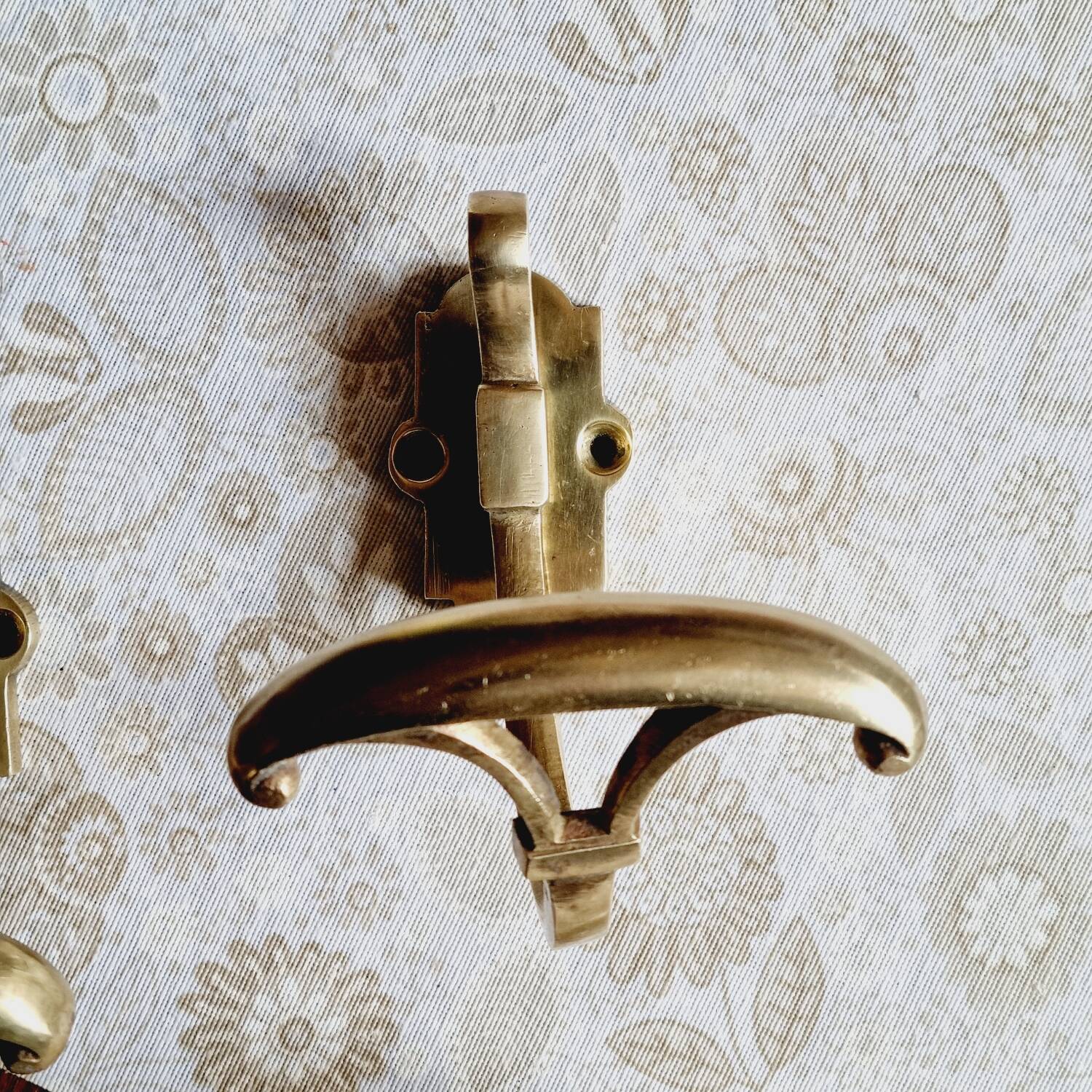 Trio of brass coat hooks or coat racks