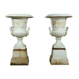 Pair of cast iron urns on plinth