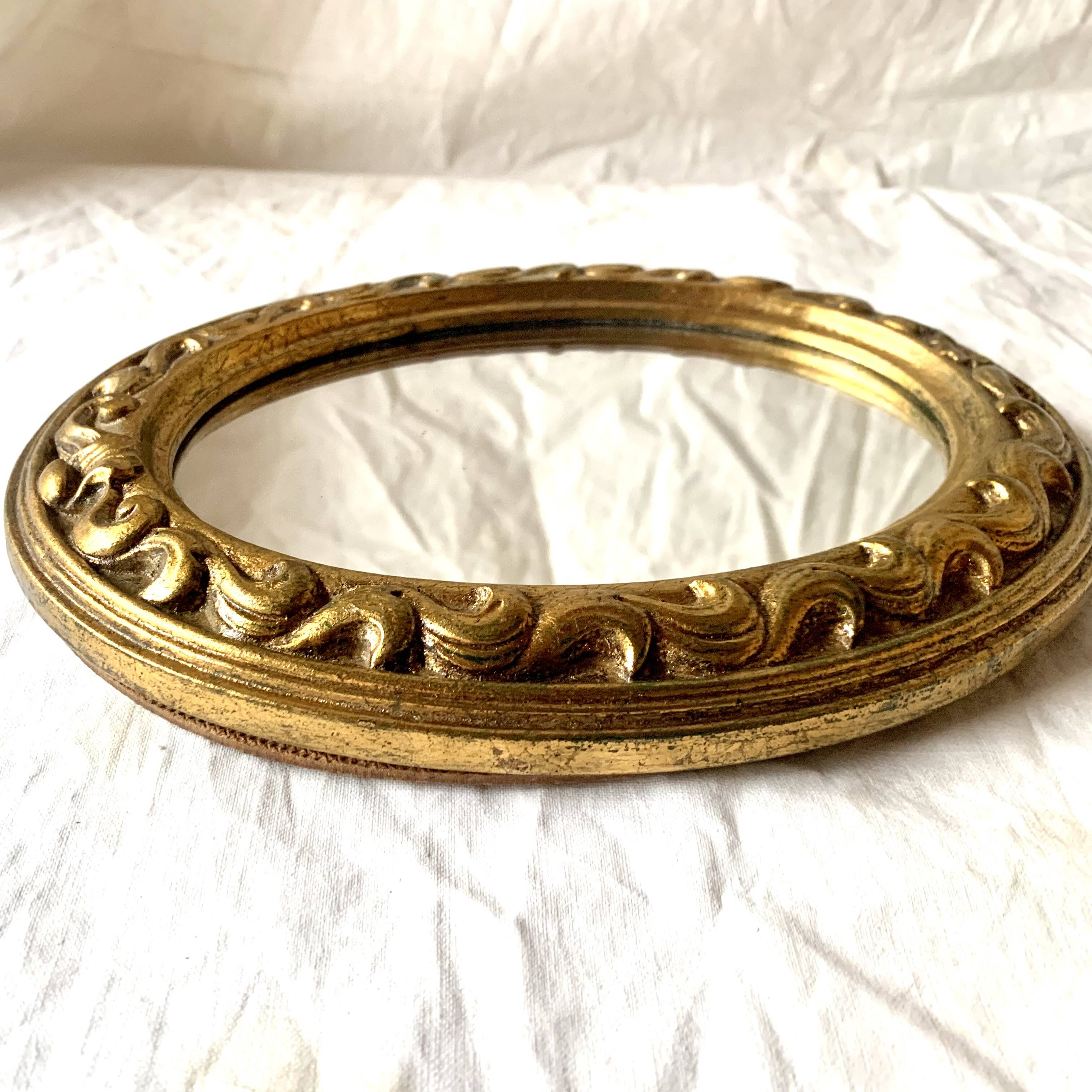 Small vintage wall mirror in gold resin