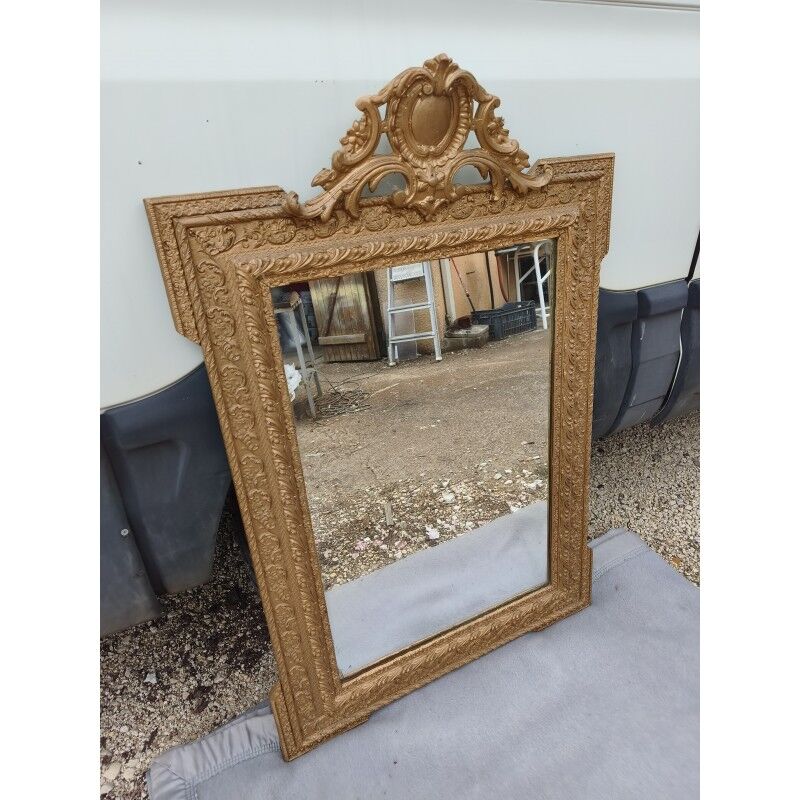 19th-century mirror in gilded wood and stucco.