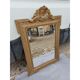 19th-century mirror in gilded wood and stucco.