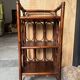 Dark brown 70s bamboo and cane shelf on legs