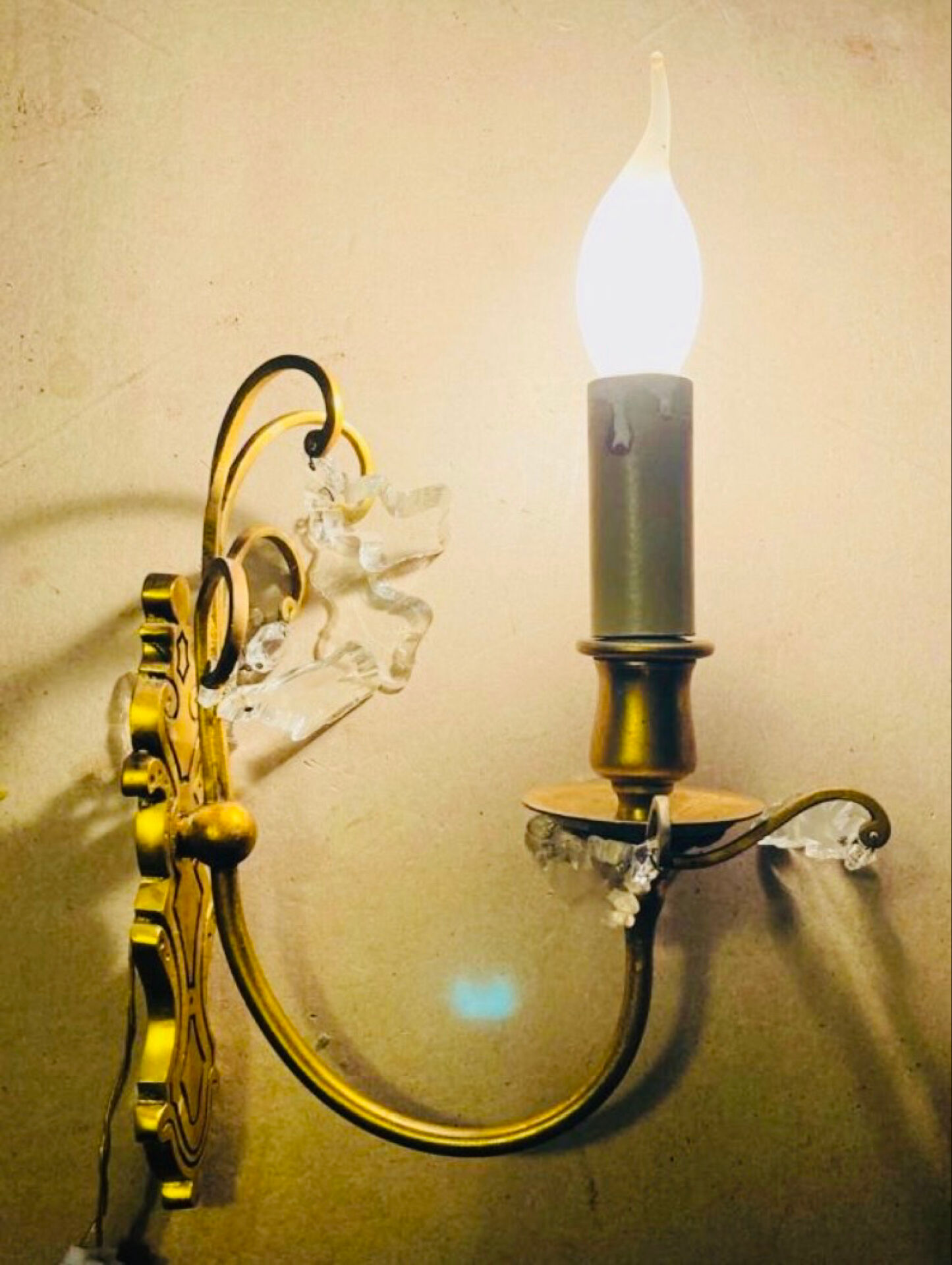 Brass wall light with glass pendants from the mid-20th century.