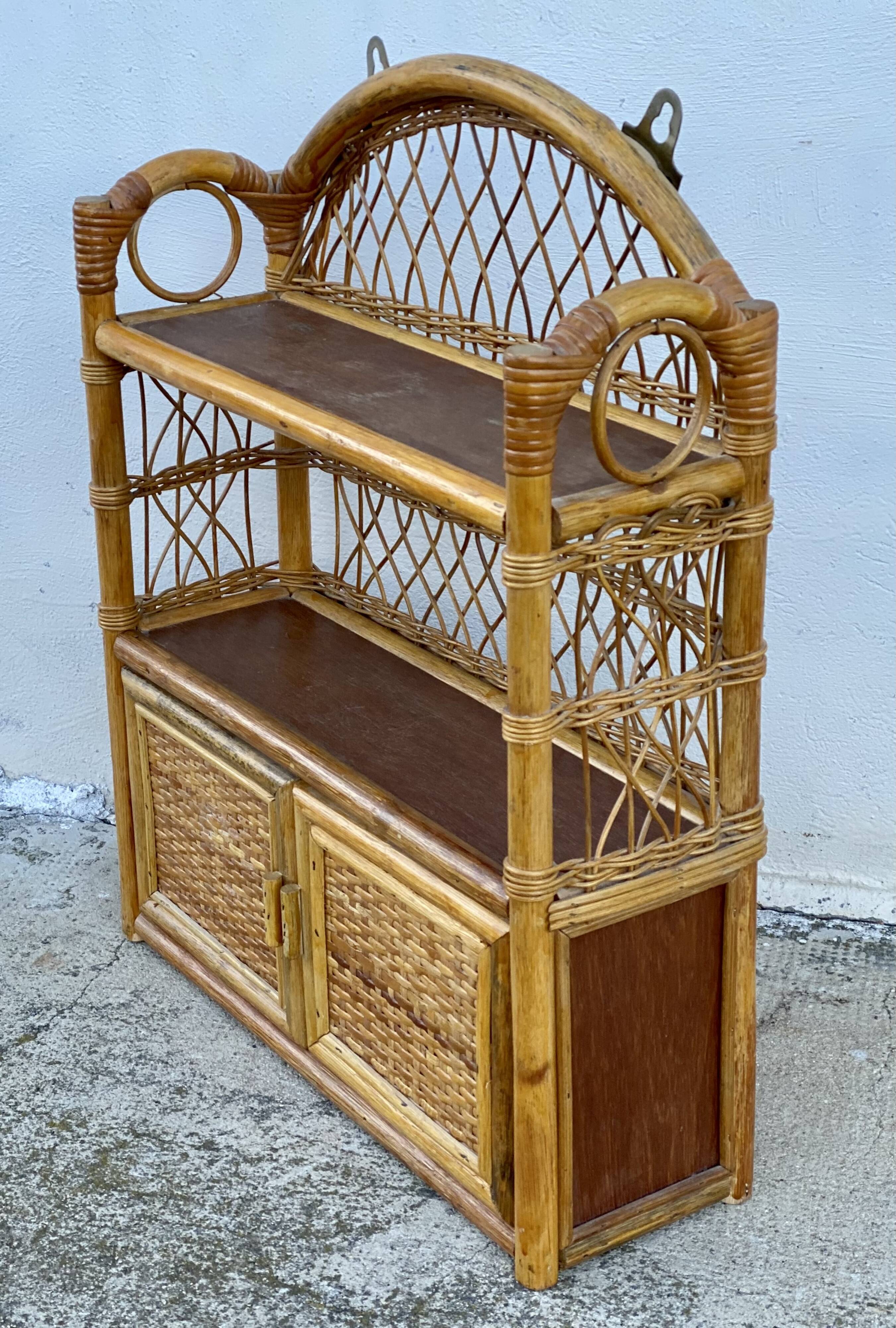 Small vintage 1970s rattan wall shelf with 2 doors.