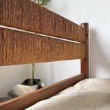 Brutalist style bed with chain and straw