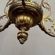 Renaissance chandelier with putti statuette.