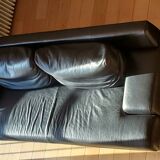Black leather three-seater sofa