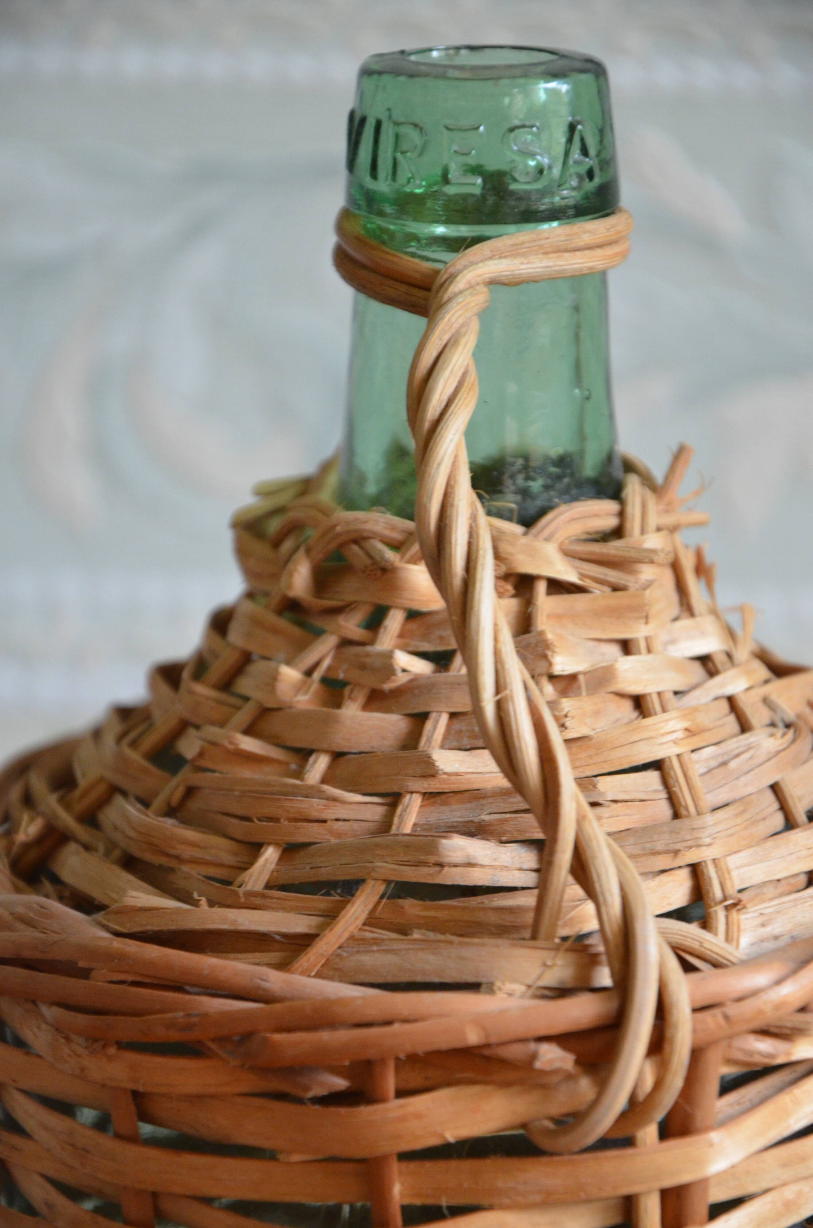 Viresa glass bottle and woven rattan