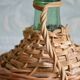 Viresa glass bottle and woven rattan