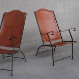 Pair of mid-century leather and metal folding armchairs
