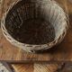 Round wicker basket with a patina