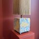 Base stuck blue beige marble-plaster, fringed lampshade Houles, 21st century.
