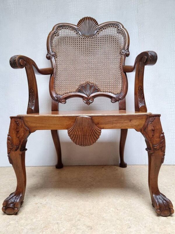 Fauteuil Bergère Chippendale, en acajou sculpté avec cannage et pieds en forme de griffes de lion.