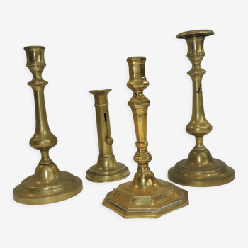 Set of four brass candle holders