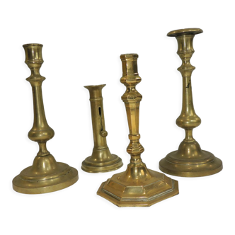 Set of four brass candle holders