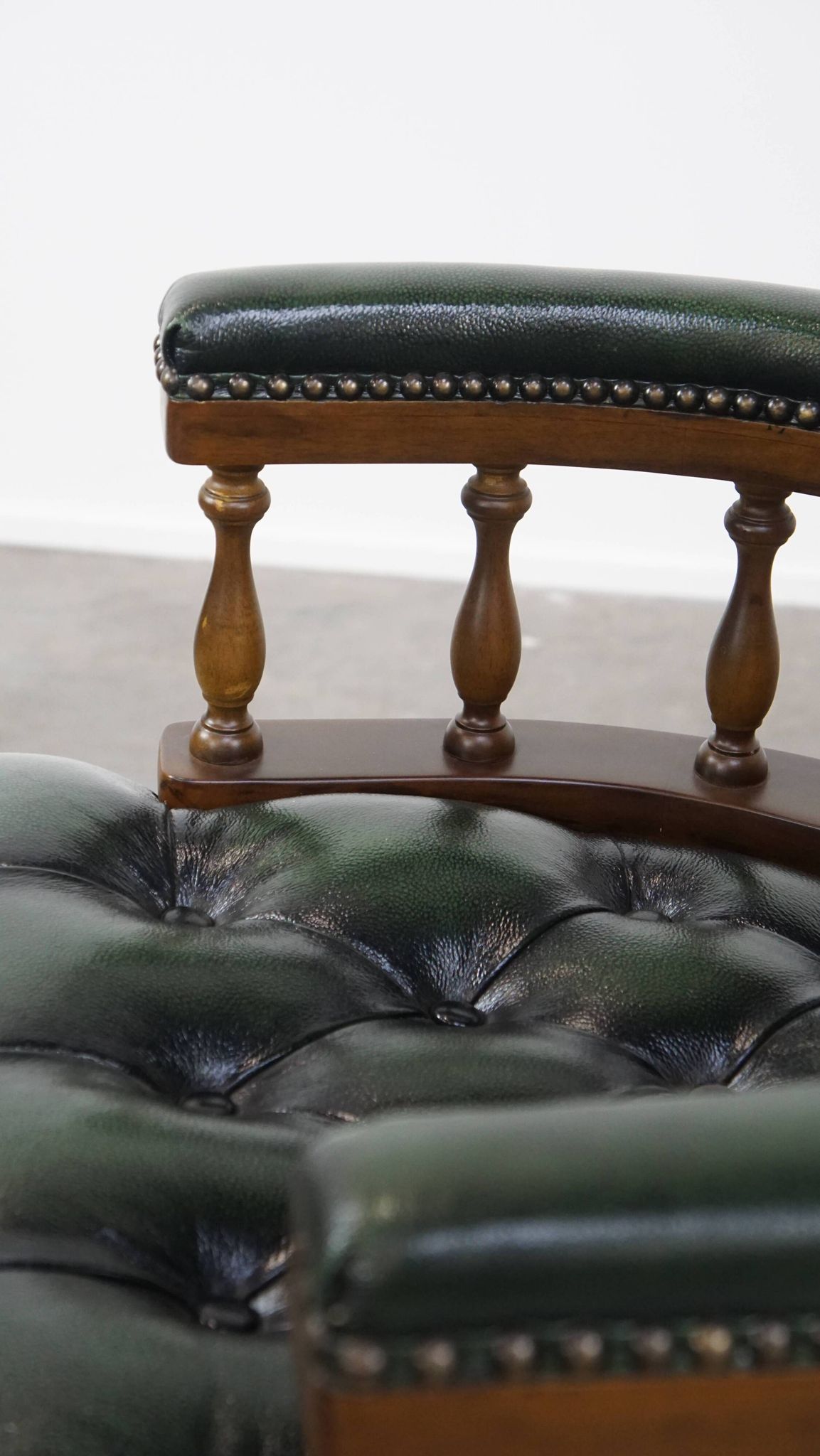 Dark green cowhide leather and wood chesterfield office chair on wheels