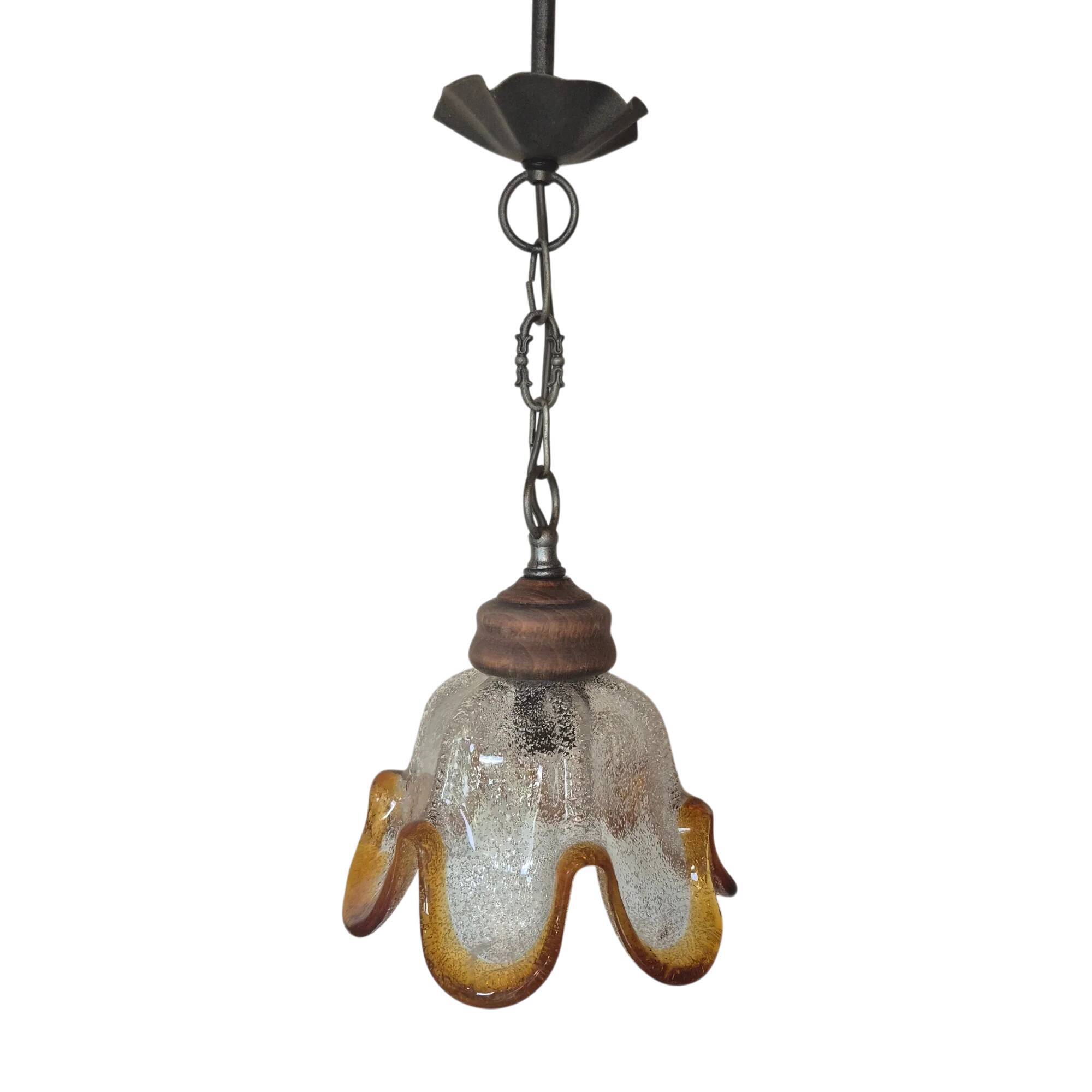 Vintage suspension with textured glass and amber-edged wood.