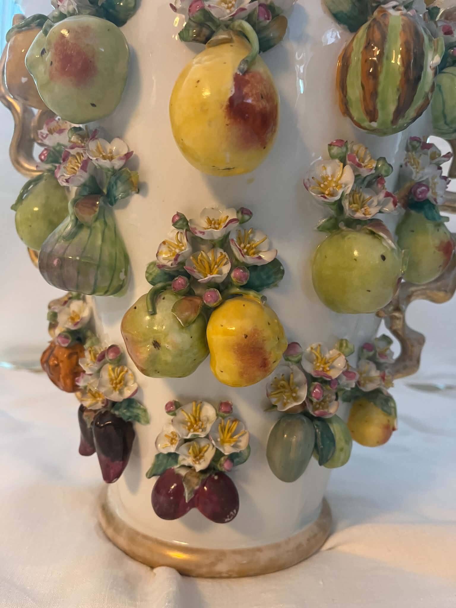 Large antique vase with relief decorations of coloured fruits.