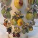 Large antique vase with relief decorations of coloured fruits.