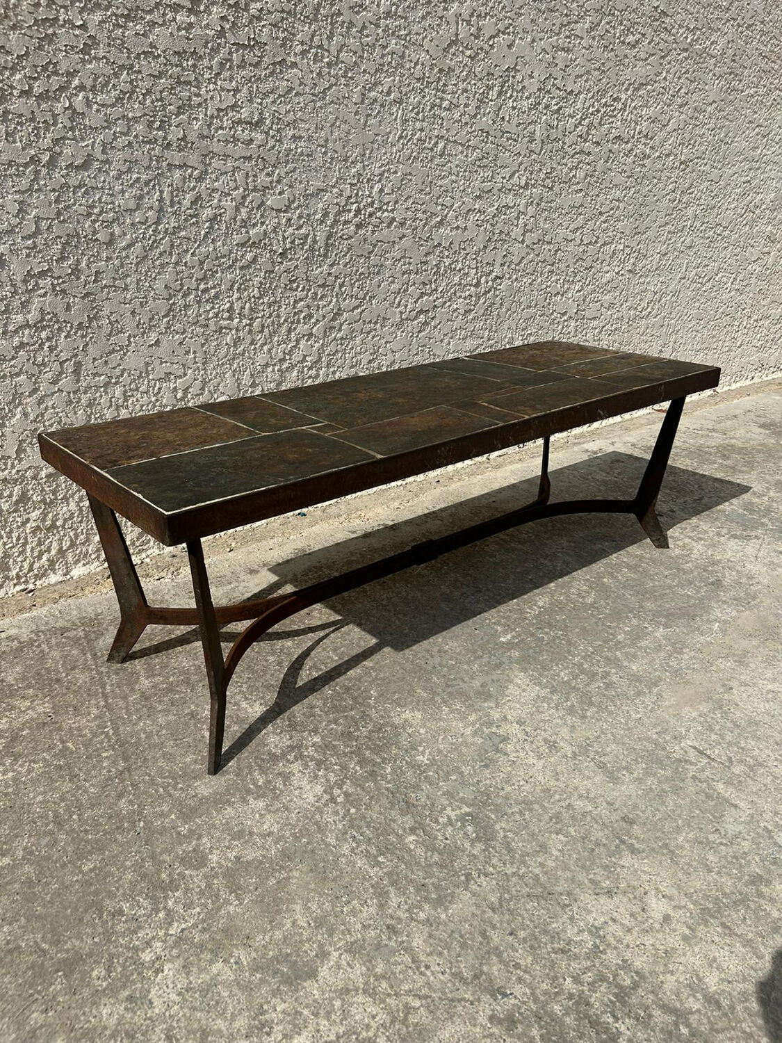 Coffee table with stone top and iron legs