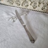 A charming set of 12 molded glass knives rests in the shape of a dog