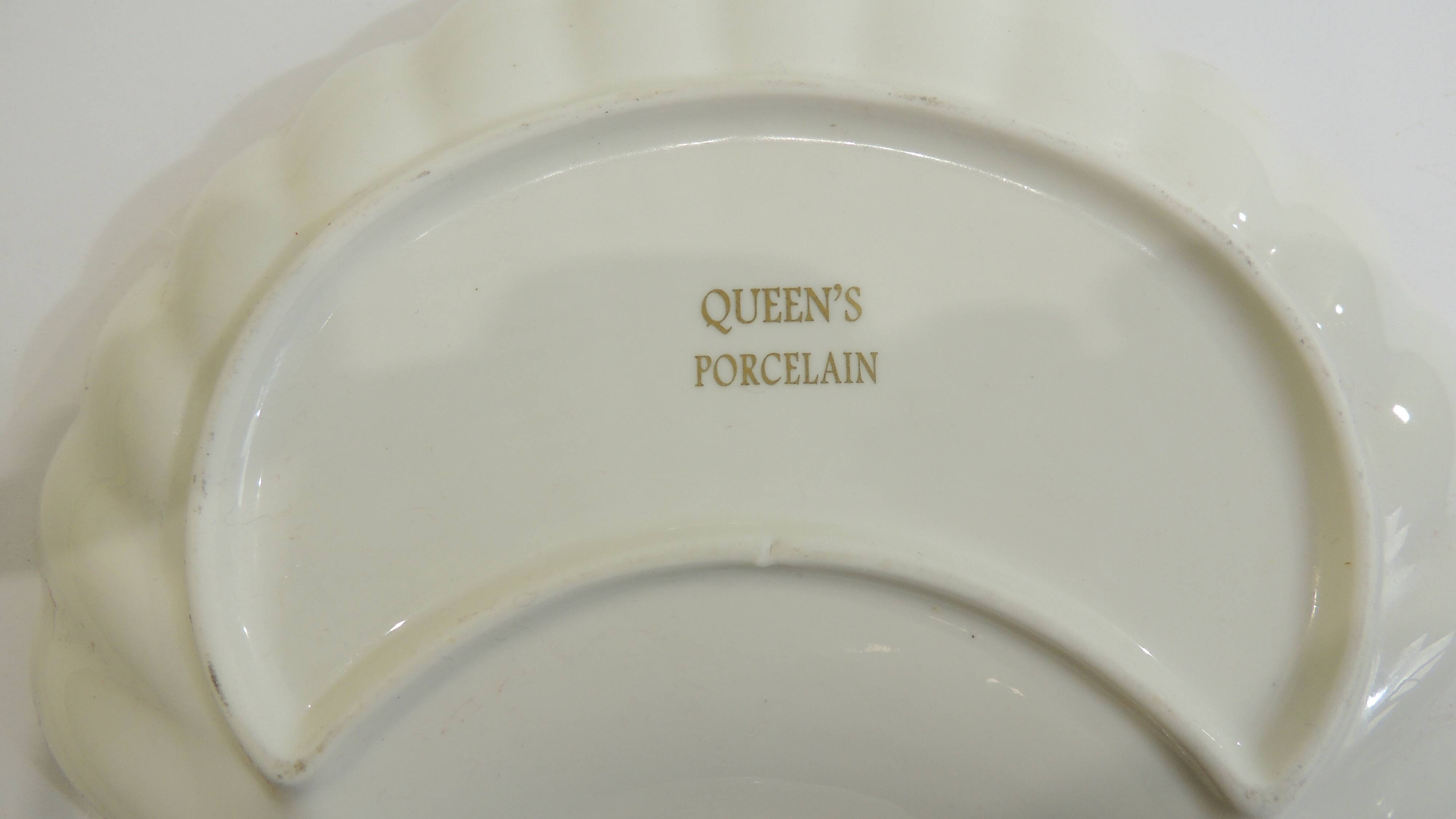 Shell-shaped porcelain pocket bowl from Queen’s Porcelain, with a gold rim.