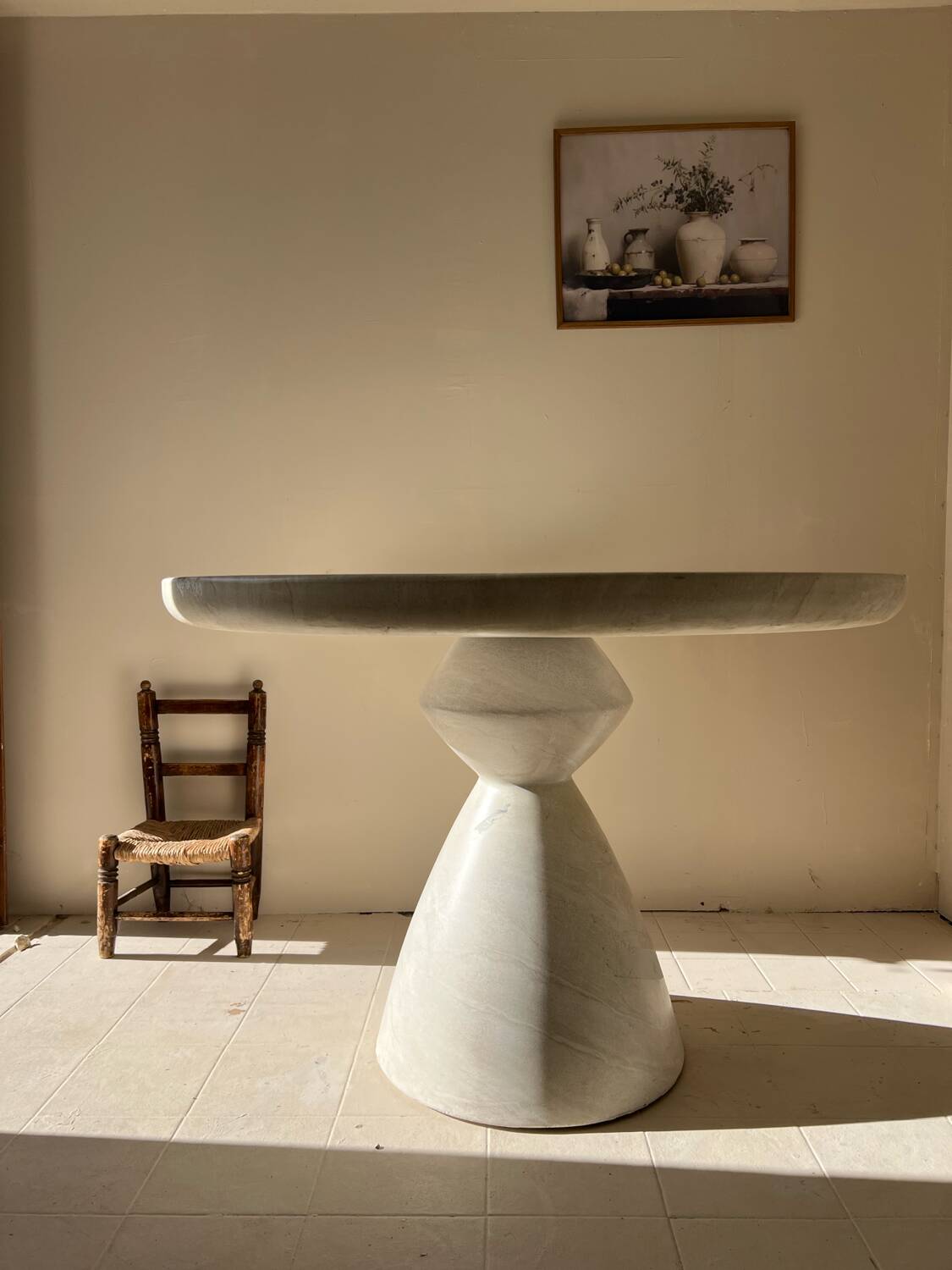 Travertine-effect stone dining table