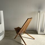 Foldable designer armchair in wooden slats