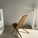 Foldable designer armchair in wooden slats