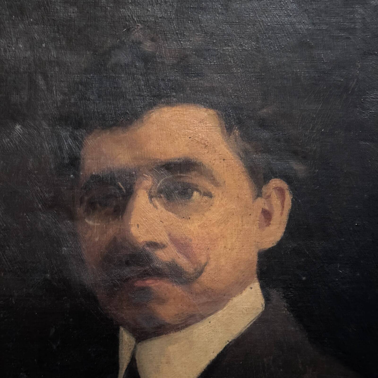 Oil on canvas portrait of a man wearing glasses and a mustache, early 20th century