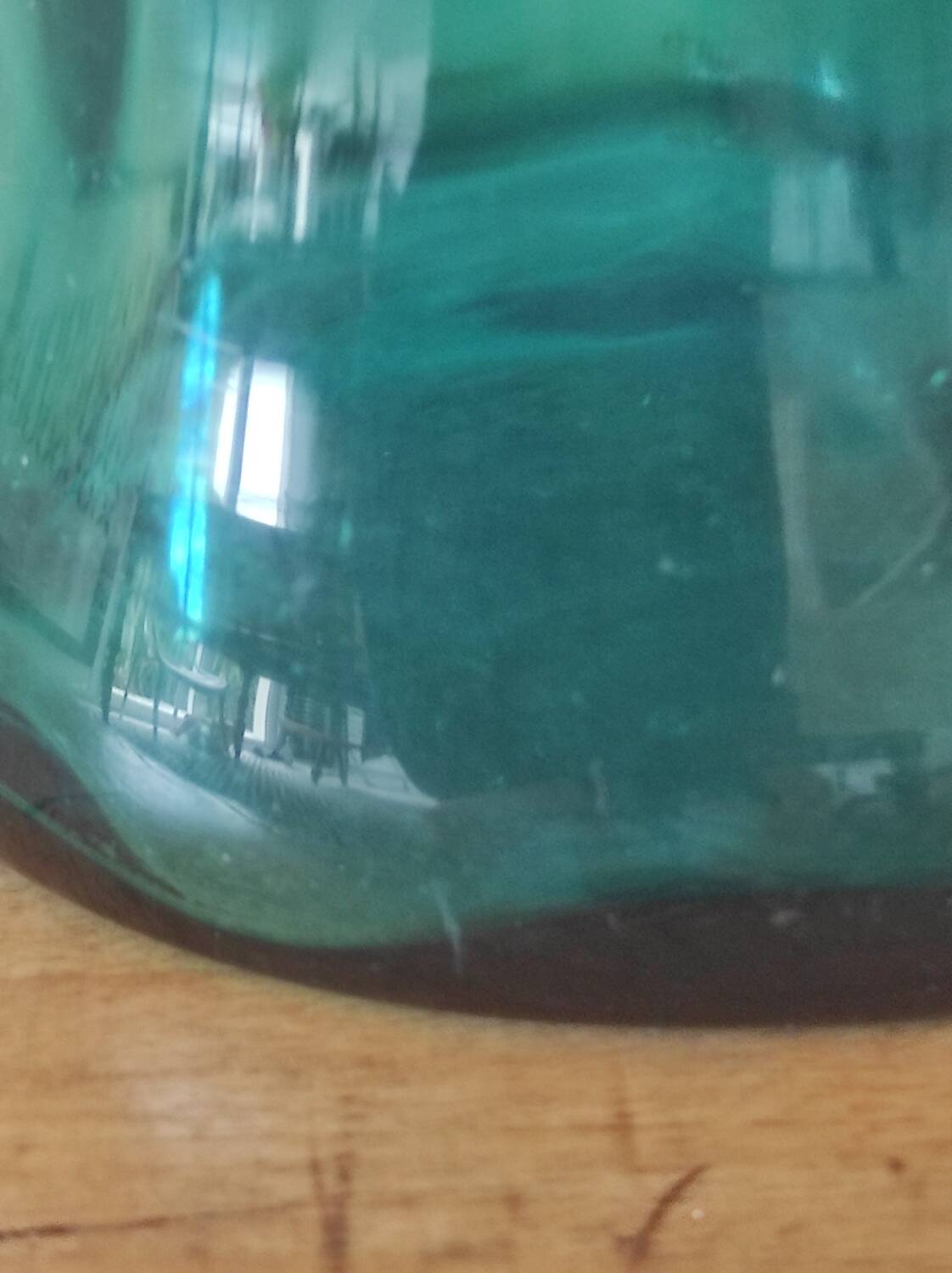 Blown glass vase with a flared neck and wavy rim.